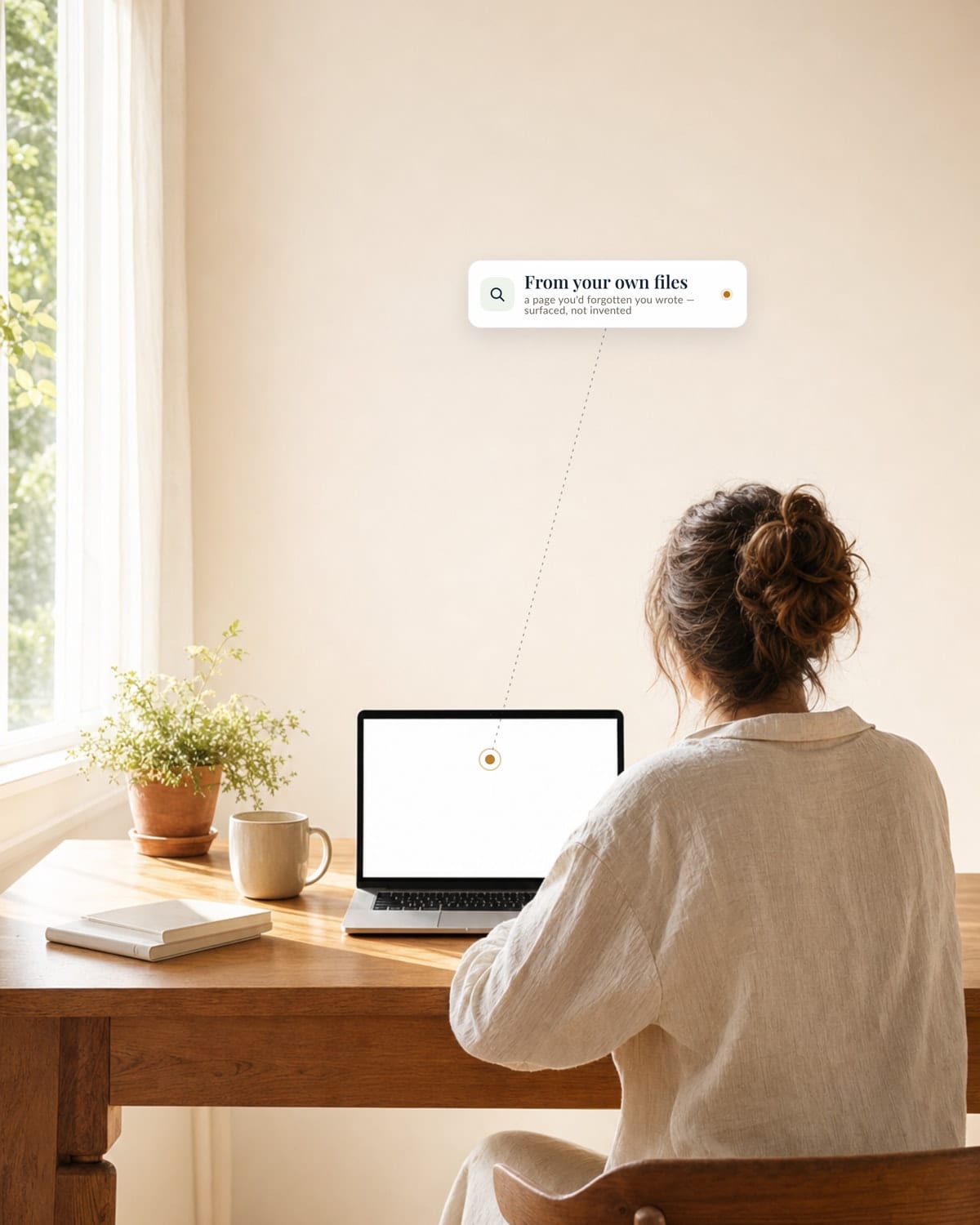 An author works at a sunlit desk with her laptop open; a small card reading &lsquo;From your own files — a page you&rsquo;d forgotten you wrote, surfaced, not invented&rsquo; points by a dashed line to something on her screen.